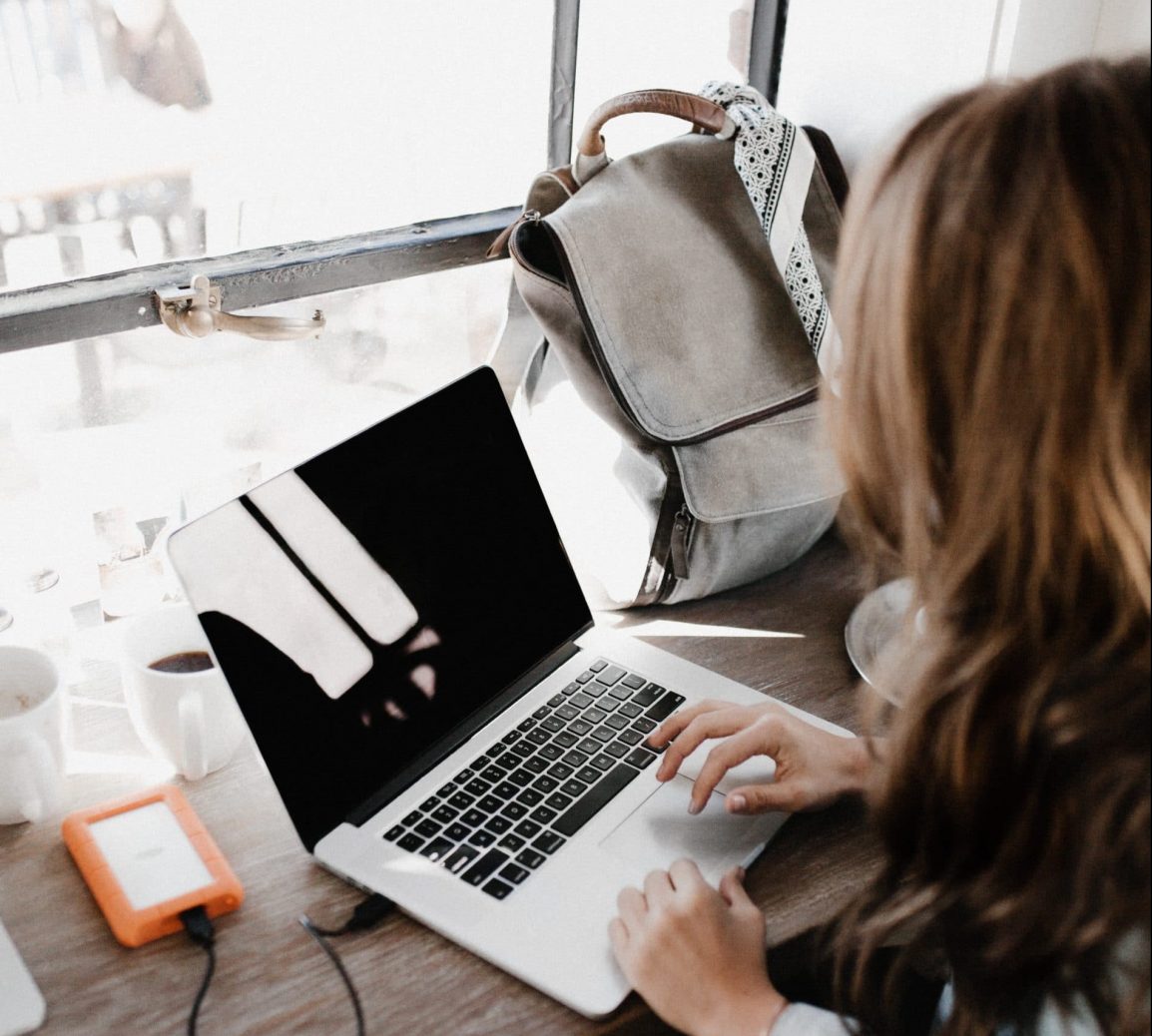 woman sitting at a desk on a computer