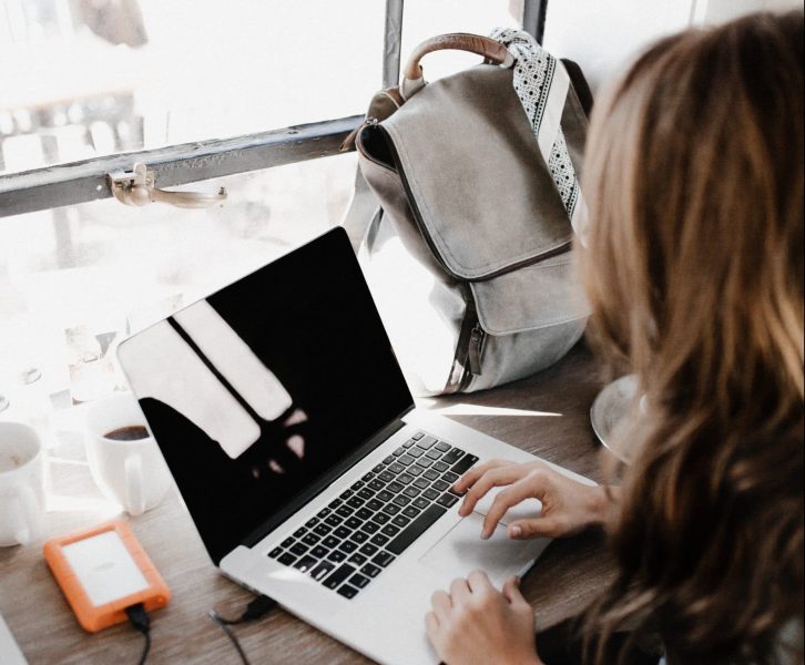 woman sitting at a desk on a computer