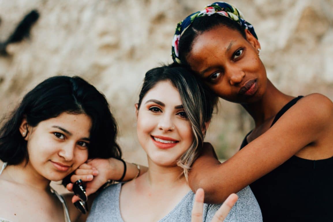 Three girls smiling at the camera