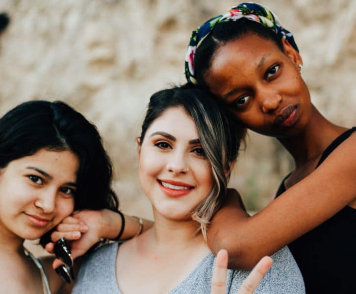 Three girls smiling at the camera