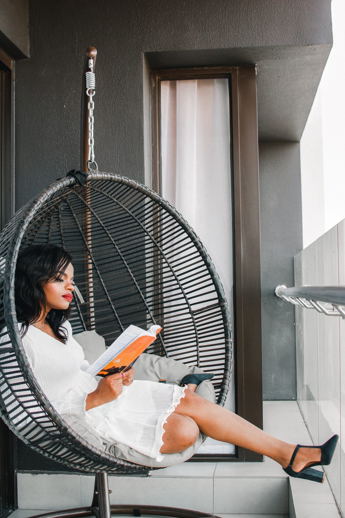 woman reads book in round seat