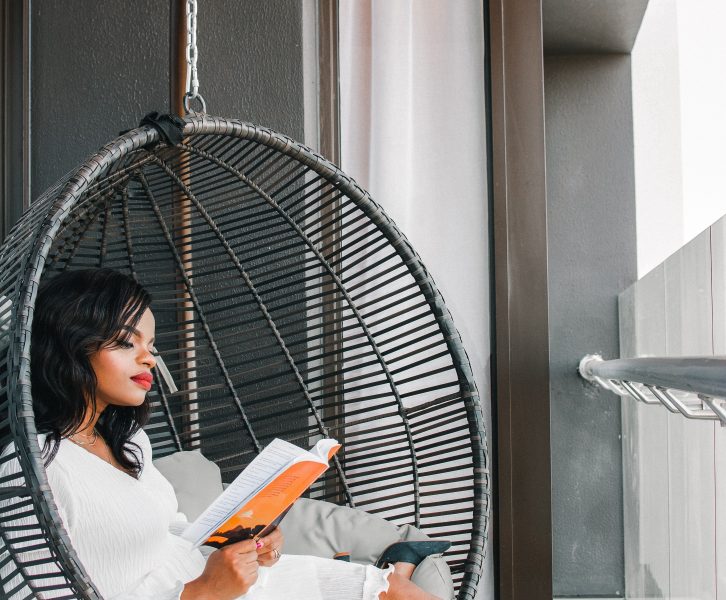 woman reads book in round seat