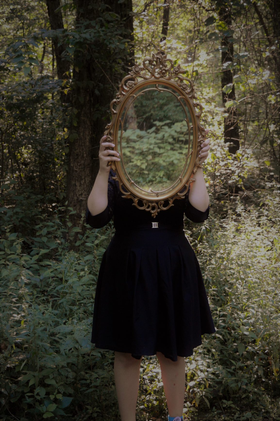 Girl holding up mirror