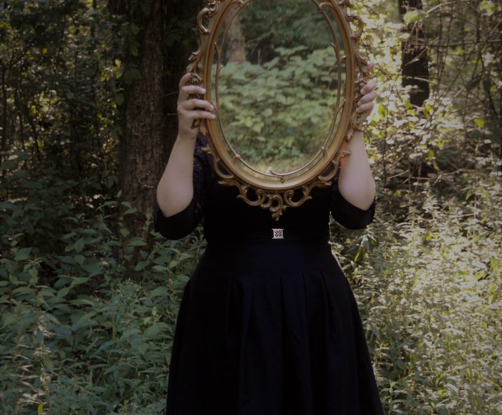 Girl holding up mirror