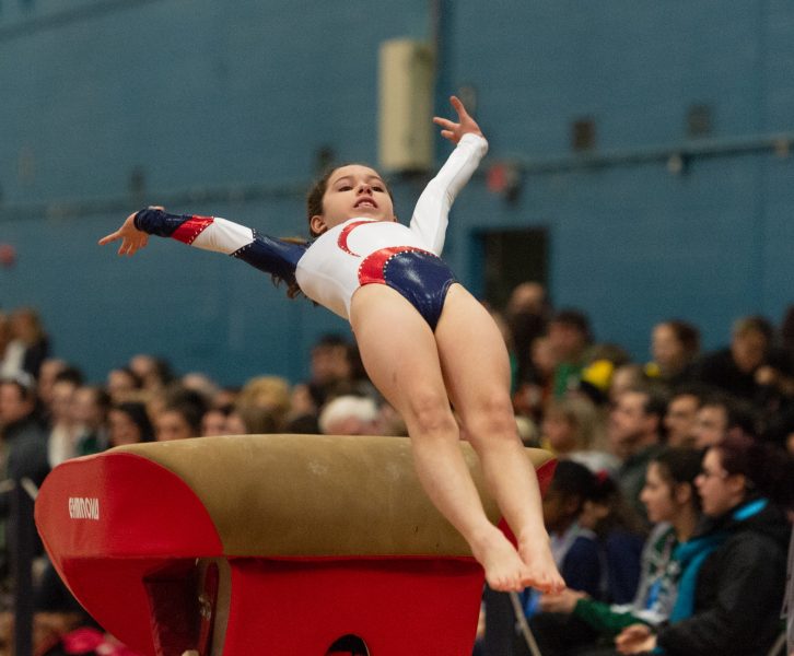 gymnast leaping over obstacle