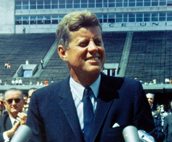 President JFK standing behind a podium