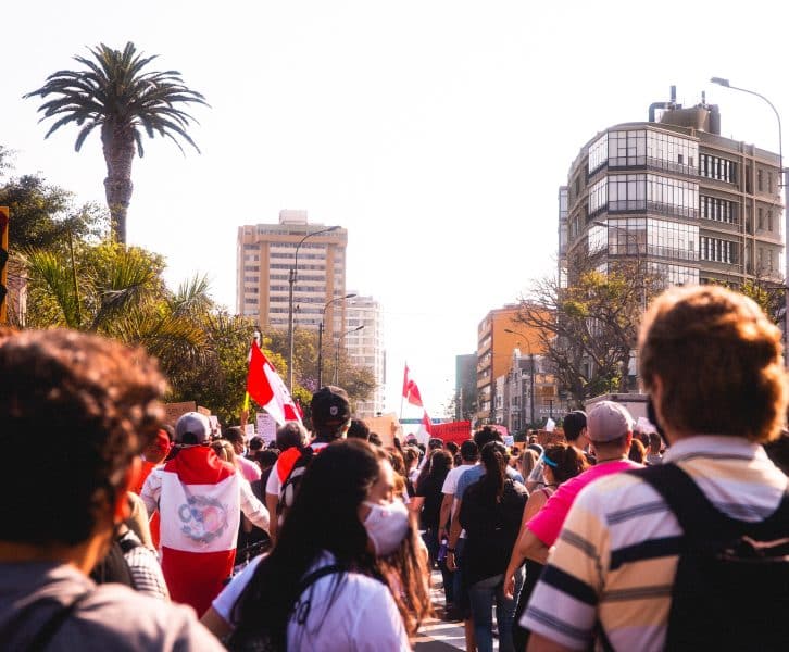 People march and display the national flag in Lima, Peru