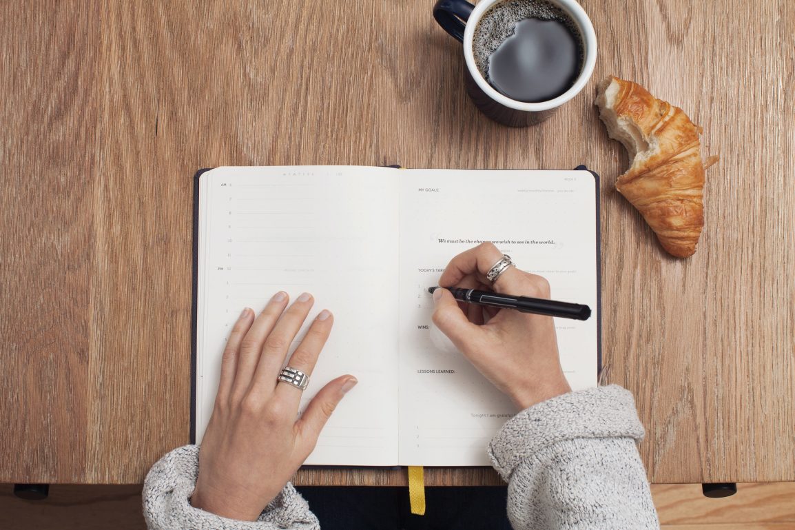 Girl writing in planner