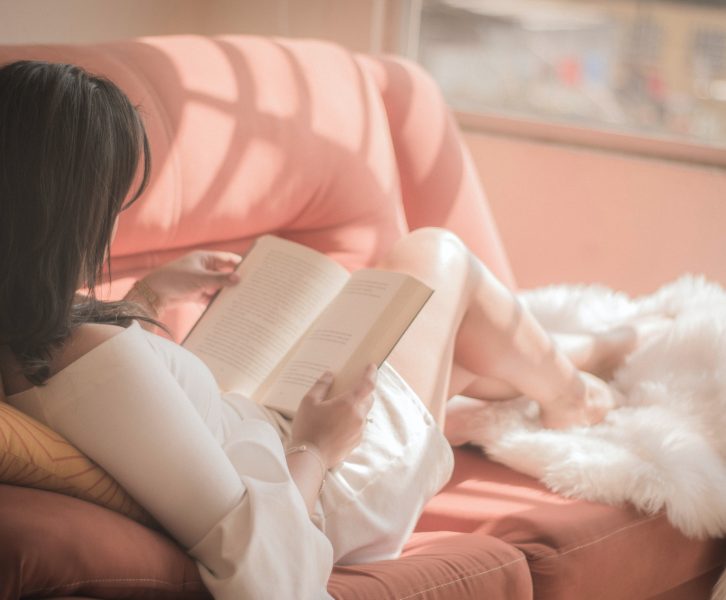 A woman reads on her couch