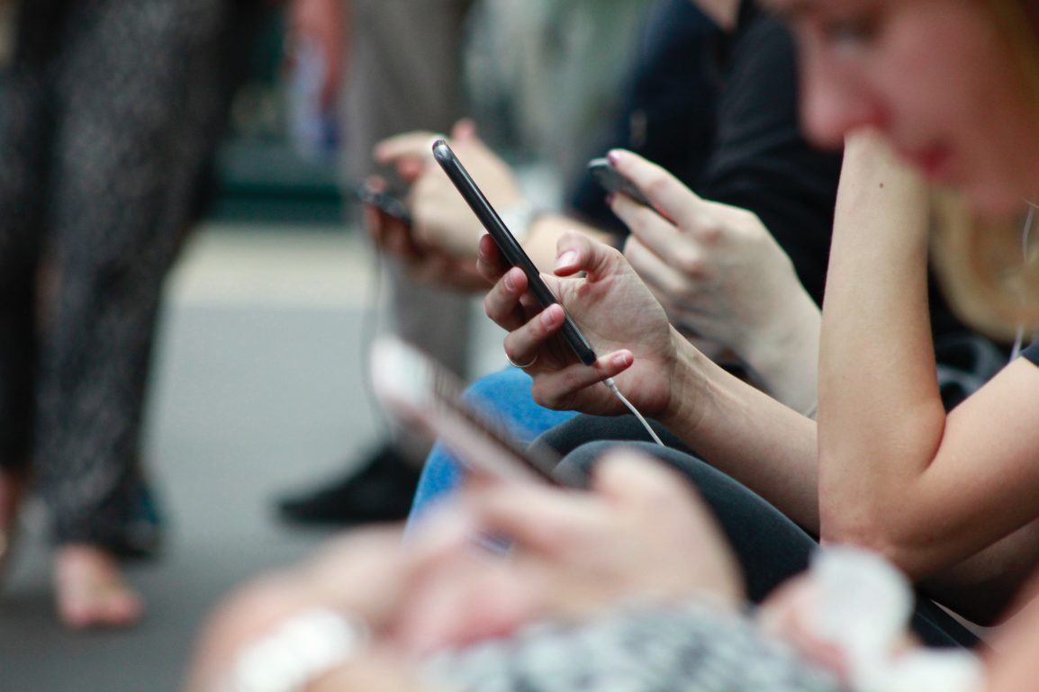 A crowd of people on their phones