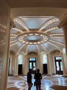 Photo of two people walking in main hallway of building