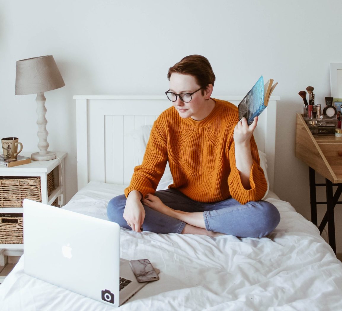 Woman studying in bed