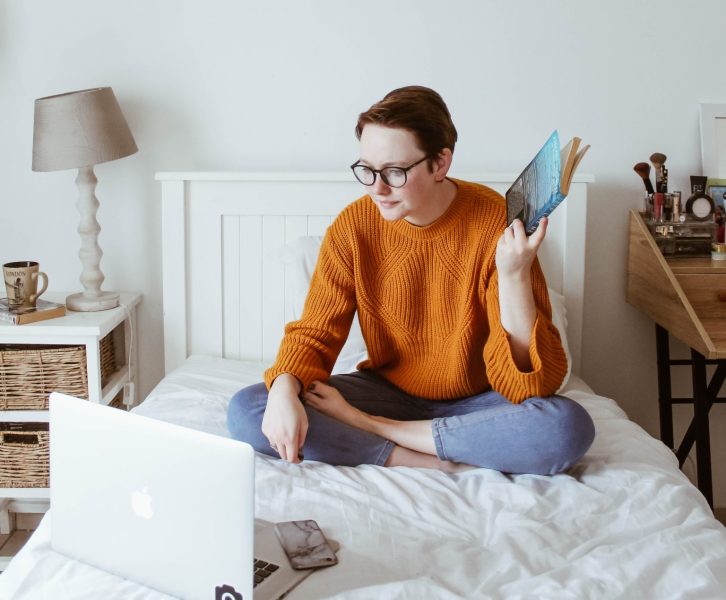 Woman studying in bed