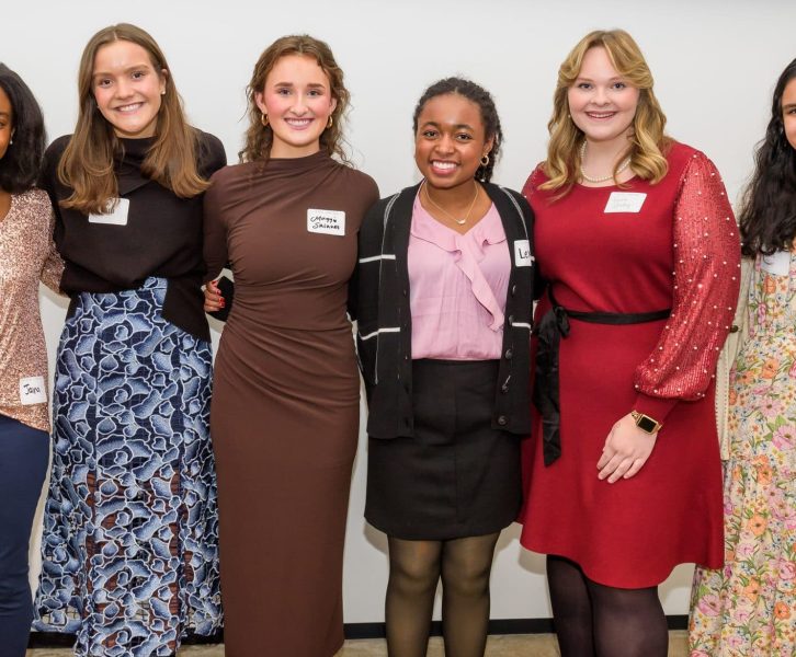 Photo of four young women smiling and standing together in a group, with a sign above them that reads "Meet the Springboarders." The image is related to a Teen Advisory Board.