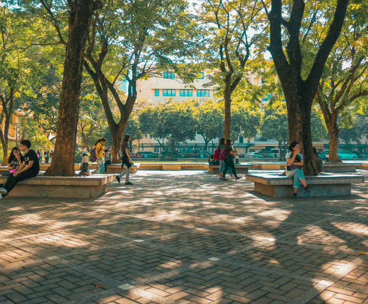 Photo of college students sitting and walking around